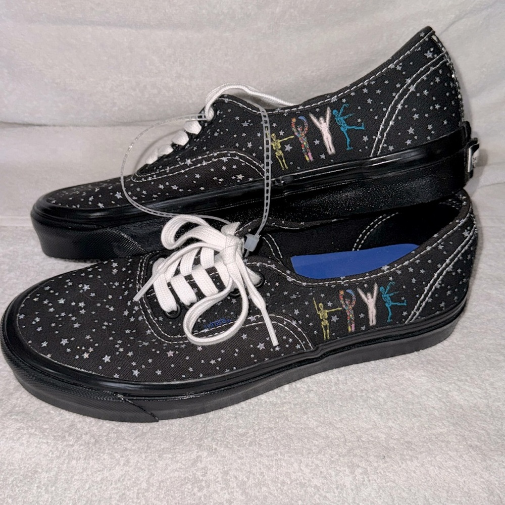 Vans (new) black with gray stars all over and cute skeletons on the sides.